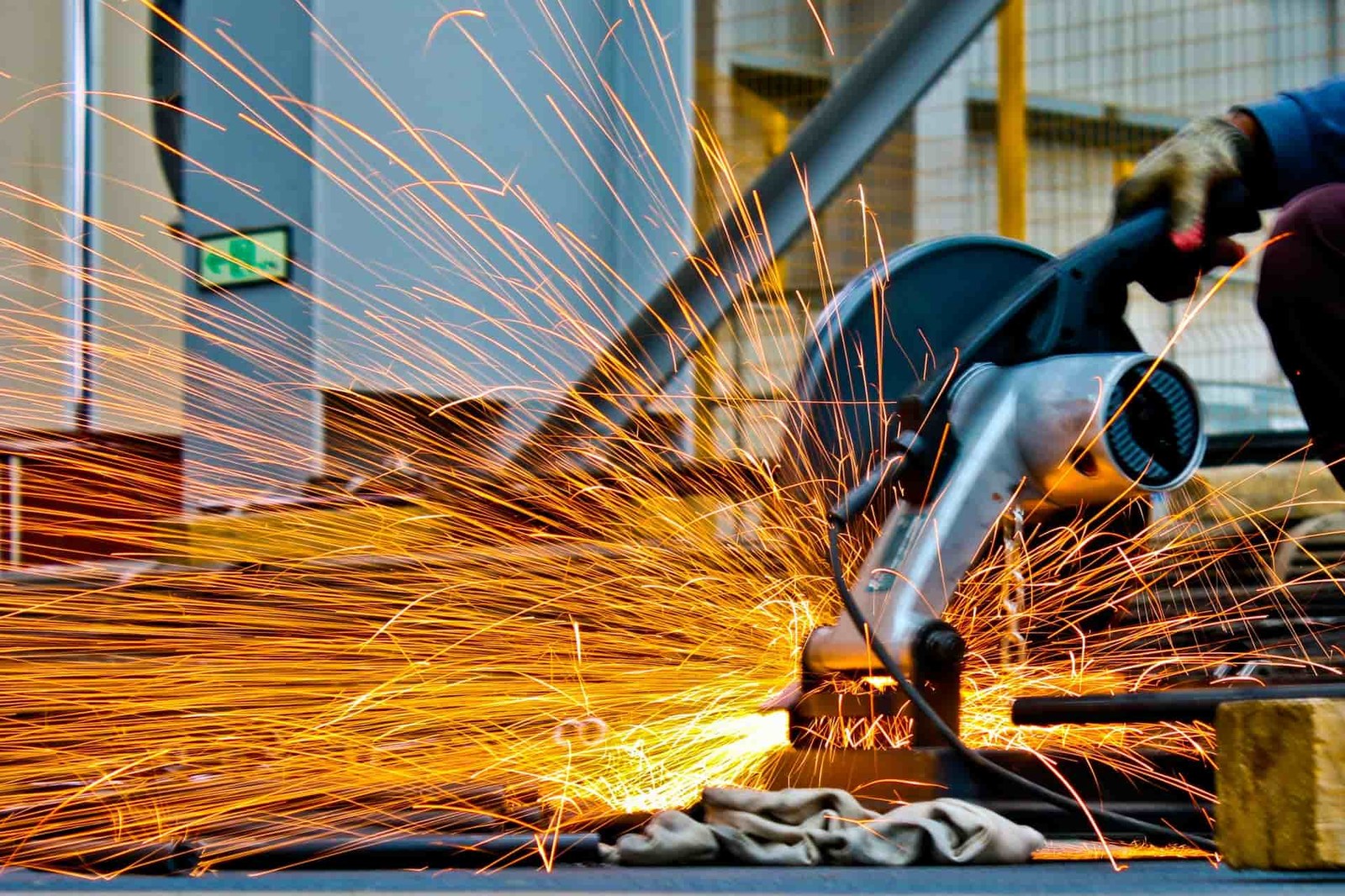 Worker restoring a surface, sparks flying